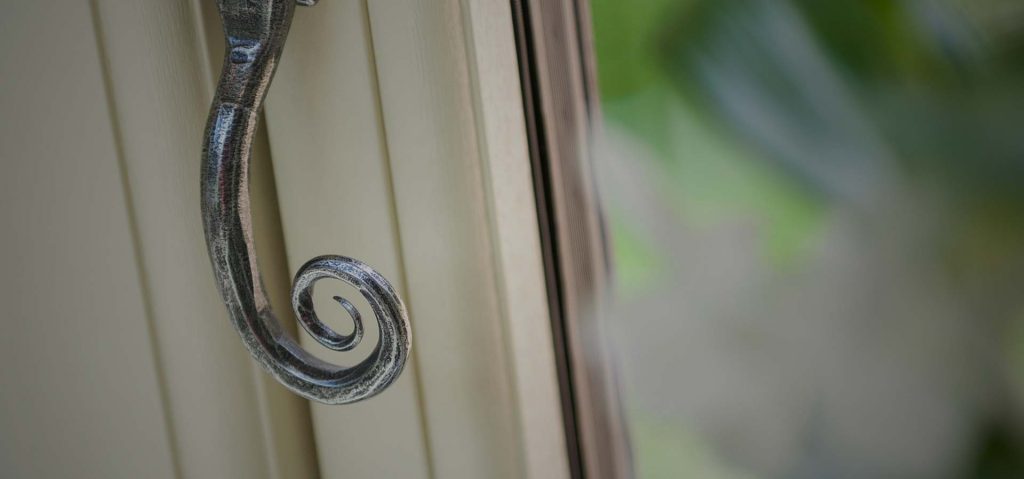 Infinity window in white uPVC with monkey tail handle for traditional look