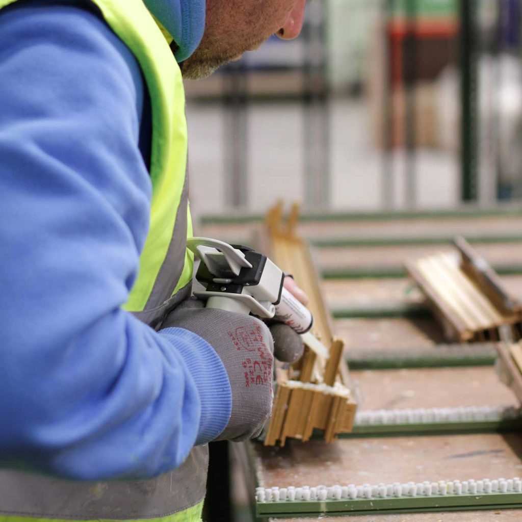 One of our manufacturing team working on a window