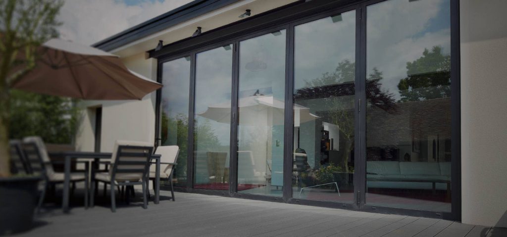 Wide span of Raum aluminium bifold doors over looking the patio area