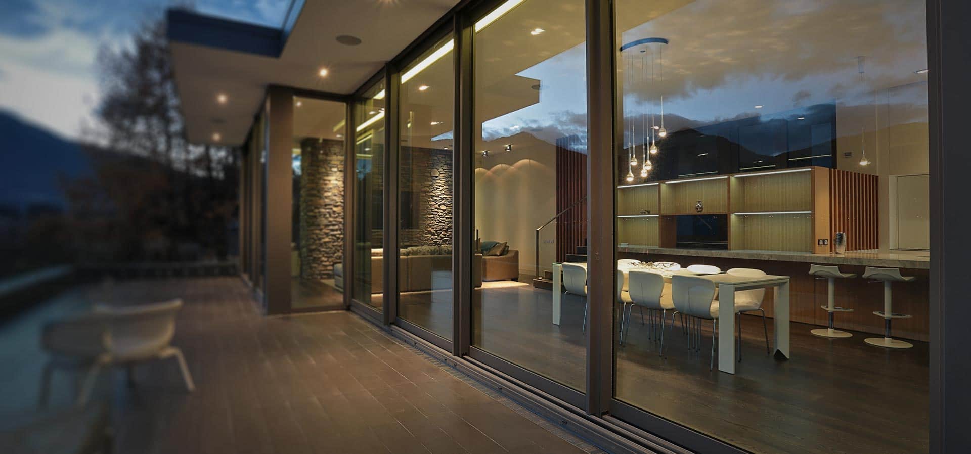 Large span of sliding aluminium patio doors with large glass area which provide a modern contemporary view