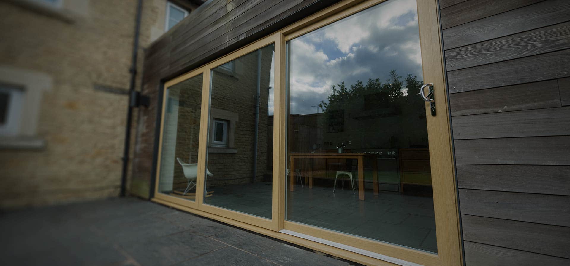 A uPVC sliding patio door in golden oak manufactured using Deceuninck's Slider24 patio door system